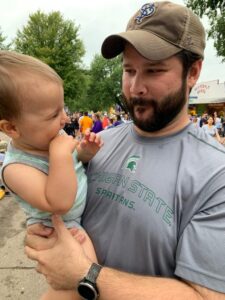 A young boy and his father make silly faces at each other